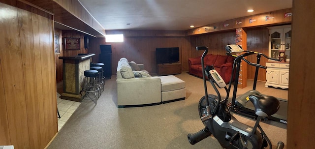 workout area featuring wood walls and recessed lighting