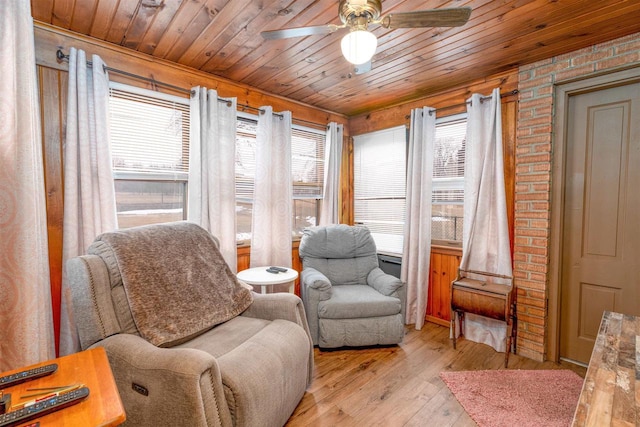 sitting room featuring a healthy amount of sunlight, light wood-type flooring, and wood ceiling