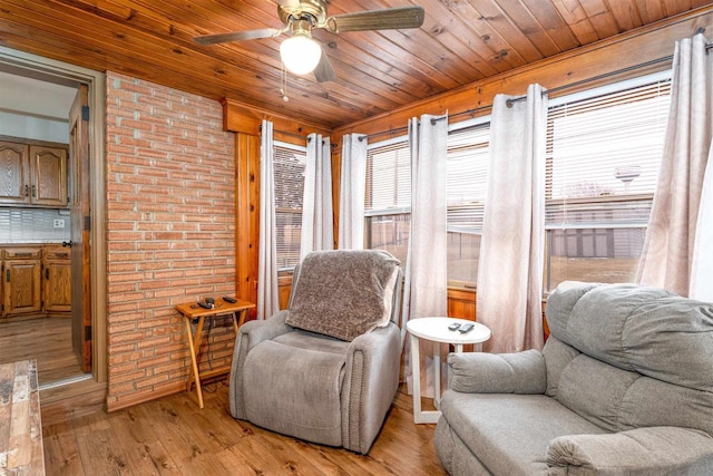 living area with light wood-type flooring, wood ceiling, and ceiling fan