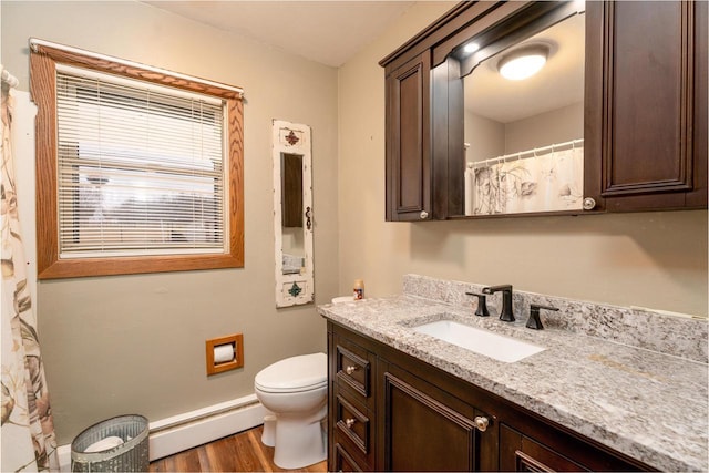 full bath featuring curtained shower, a baseboard radiator, toilet, wood finished floors, and vanity