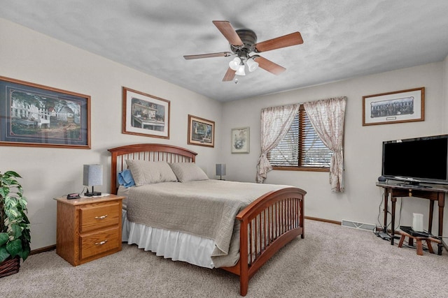 bedroom featuring light carpet, ceiling fan, visible vents, and baseboards