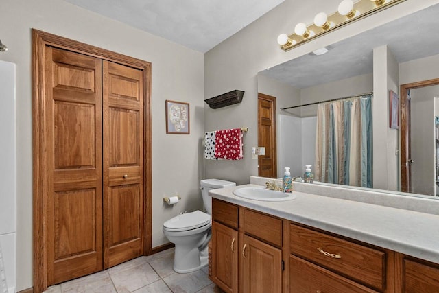 bathroom with toilet, curtained shower, tile patterned flooring, vanity, and a closet