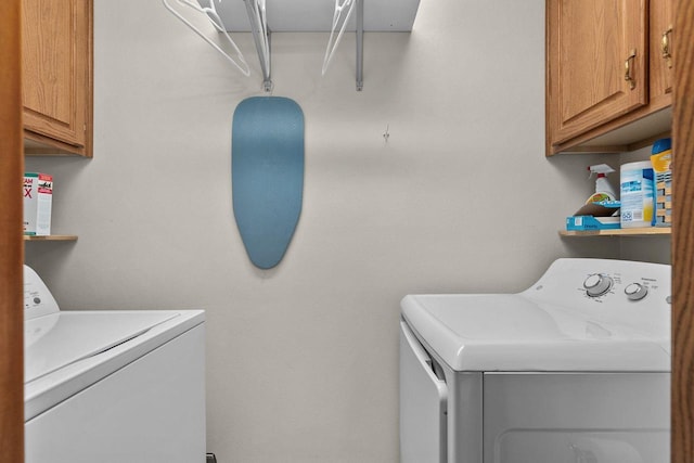 washroom with washer and dryer and cabinet space