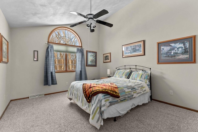 carpeted bedroom featuring a ceiling fan, visible vents, and baseboards