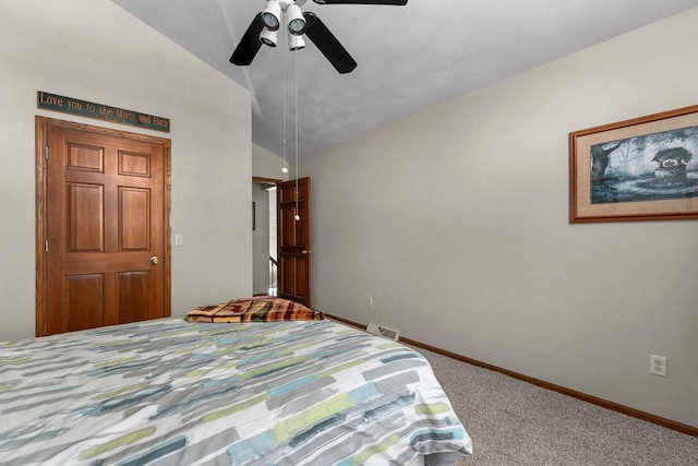 unfurnished bedroom with ceiling fan, carpet floors, visible vents, baseboards, and vaulted ceiling