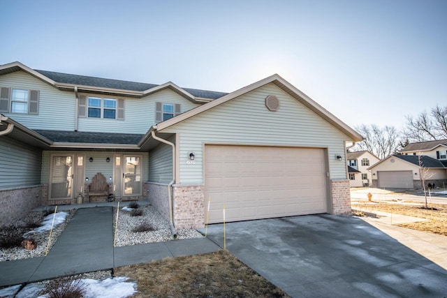 view of front of property with driveway, a garage, a porch, and brick siding