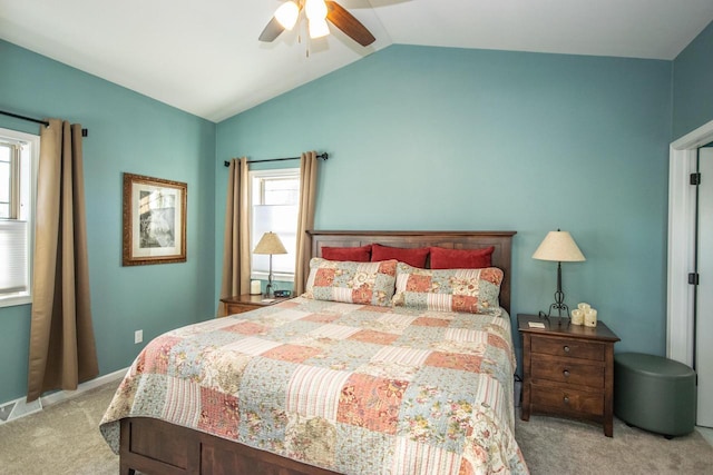 bedroom featuring ceiling fan, vaulted ceiling, and light colored carpet