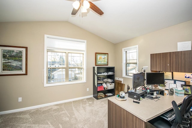 office space with lofted ceiling, light carpet, ceiling fan, and baseboards