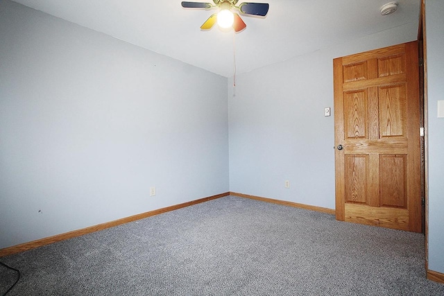 spare room featuring carpet floors, ceiling fan, and baseboards