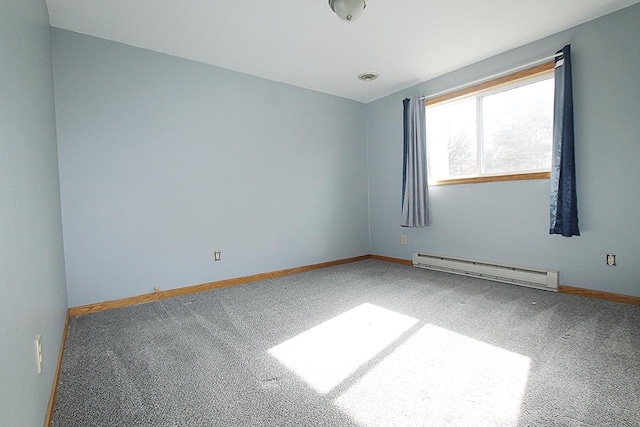 carpeted empty room featuring a baseboard heating unit, visible vents, and baseboards