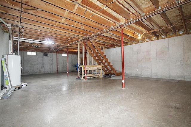 below grade area featuring stairway and gas water heater