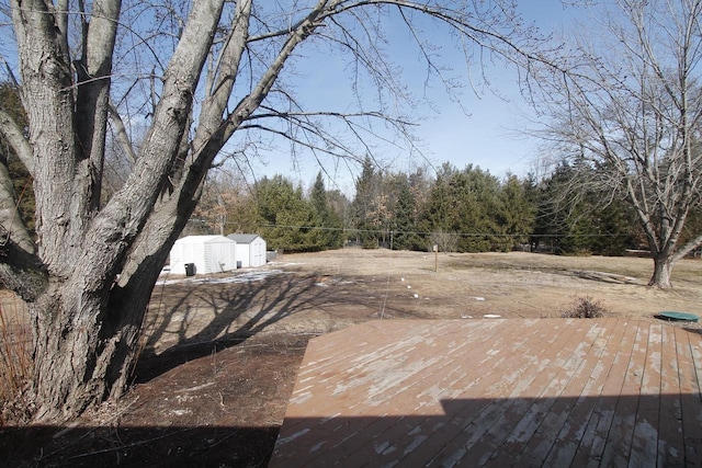 exterior space with an outbuilding, fence, and a storage unit