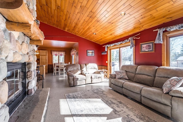 living area featuring lofted ceiling, wooden ceiling, a fireplace, and plenty of natural light