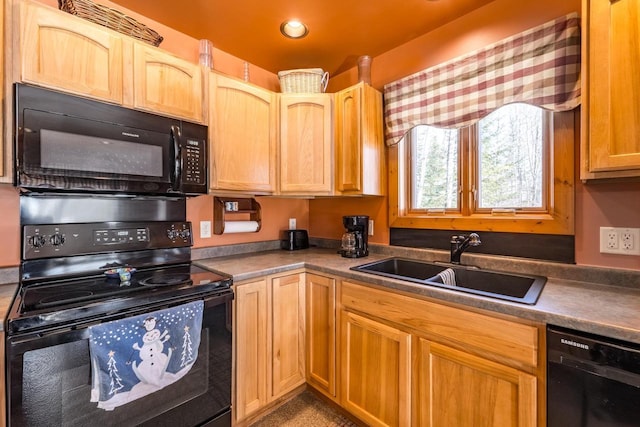 kitchen featuring black appliances, dark countertops, a sink, and recessed lighting