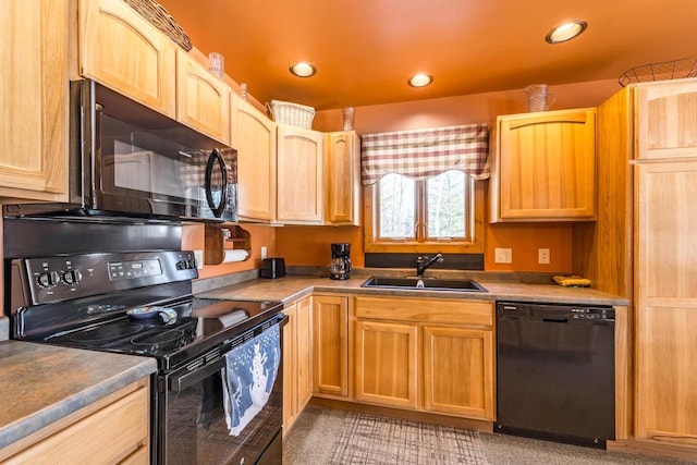 kitchen with dark countertops, black appliances, a sink, and recessed lighting