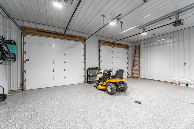 garage with metal wall and a garage door opener