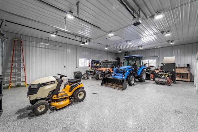 garage featuring metal wall and a garage door opener