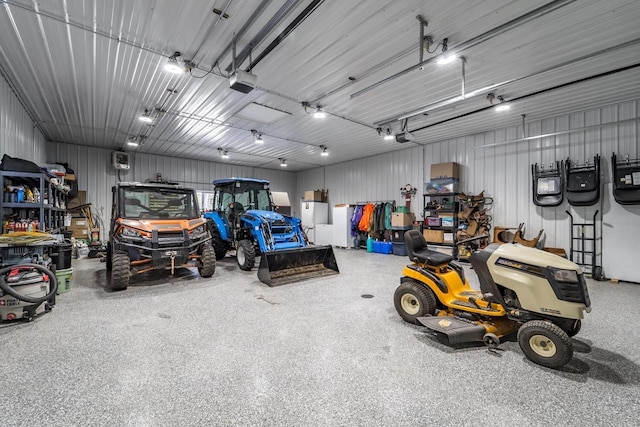 garage with a garage door opener and metal wall