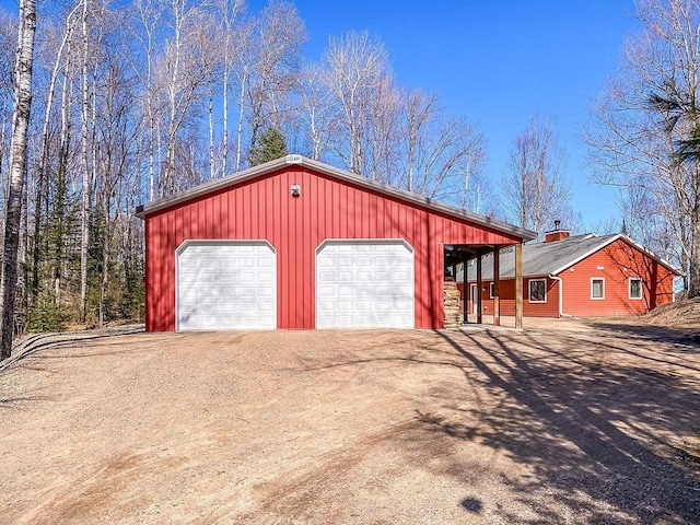 detached garage with dirt driveway