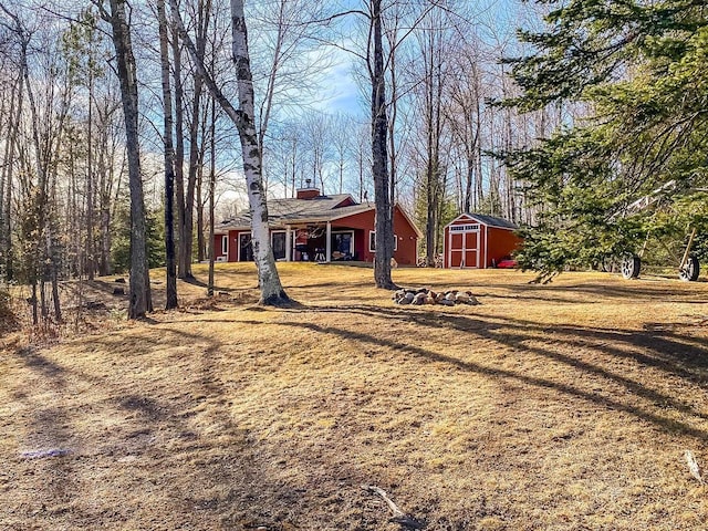 view of yard with an outbuilding and a storage shed