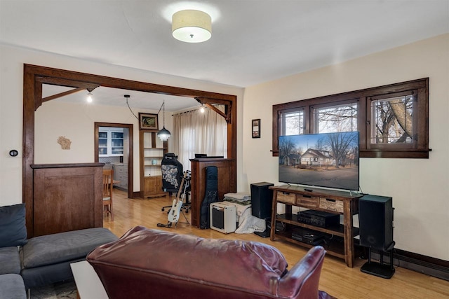 living room featuring light wood finished floors and baseboards