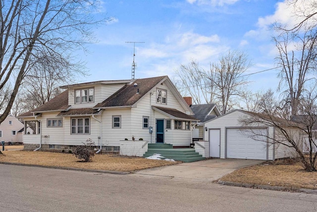 view of front of home with a garage, an outbuilding, and roof with shingles