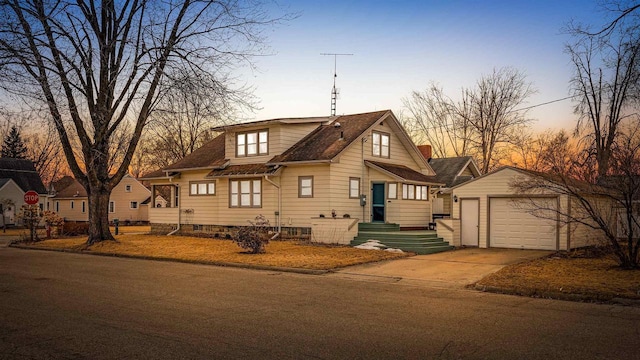 view of front facade featuring a garage, driveway, and an outdoor structure