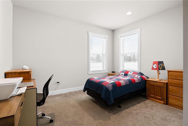 bedroom with carpet flooring and baseboards