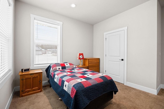 bedroom featuring light carpet, multiple windows, baseboards, and recessed lighting