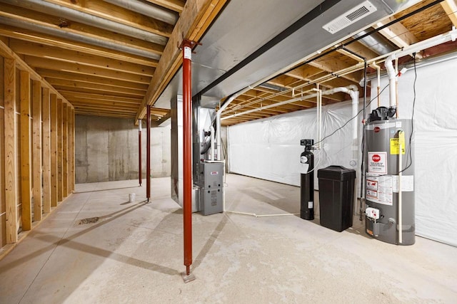 unfinished below grade area featuring gas water heater, visible vents, and heating unit