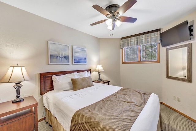 carpeted bedroom with a ceiling fan and baseboards