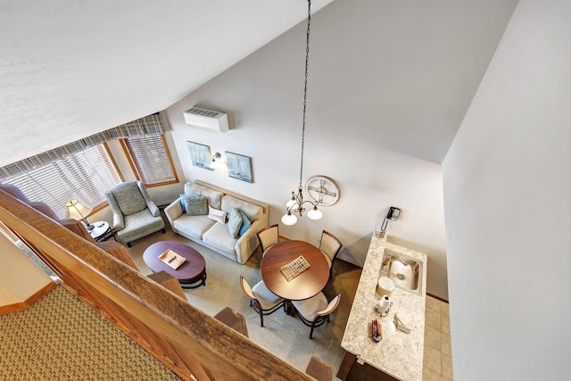 carpeted living room with a sink, an AC wall unit, and lofted ceiling