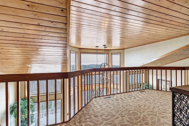 corridor with carpet floors, wooden ceiling, and visible vents