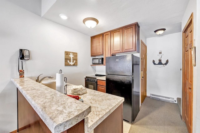 kitchen featuring brown cabinets, light countertops, a baseboard heating unit, a peninsula, and black appliances