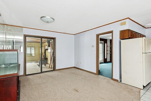 spare room with light carpet, baseboards, and ornamental molding