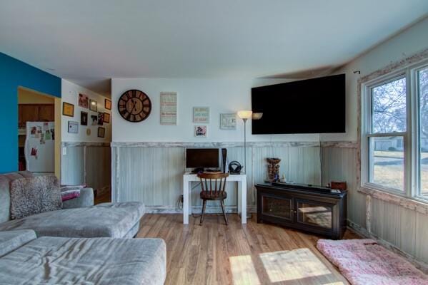 living room with wood finished floors and wainscoting