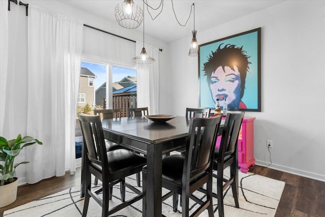 dining room featuring baseboards and wood finished floors