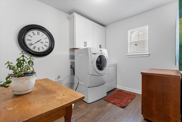 clothes washing area featuring cabinet space, baseboards, dark wood-style floors, and washer and dryer