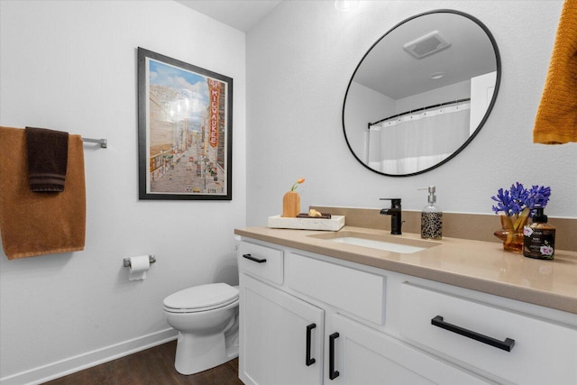 full bath featuring baseboards, visible vents, toilet, wood finished floors, and vanity