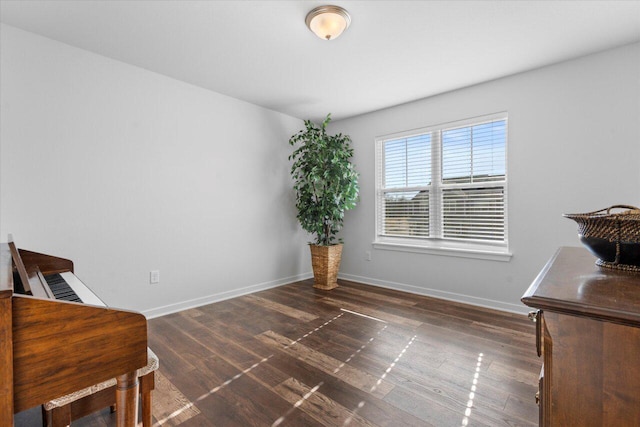 living area featuring baseboards and wood finished floors