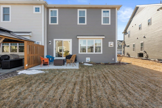 rear view of house with central AC and a patio area