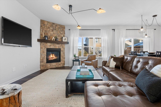 living room with a fireplace, wood finished floors, and baseboards