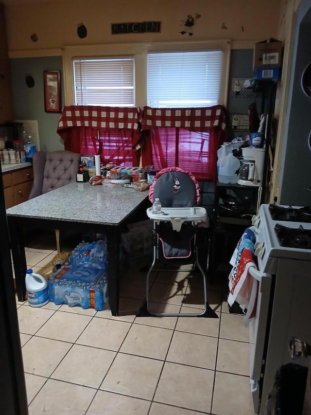 kitchen featuring white gas range oven and tile patterned floors