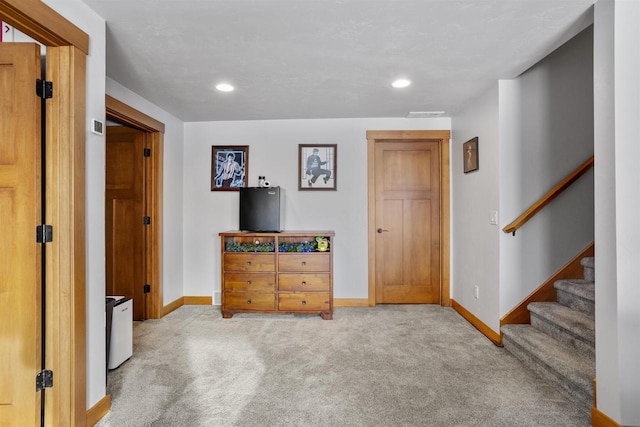 interior space featuring baseboards, stairway, recessed lighting, and light colored carpet