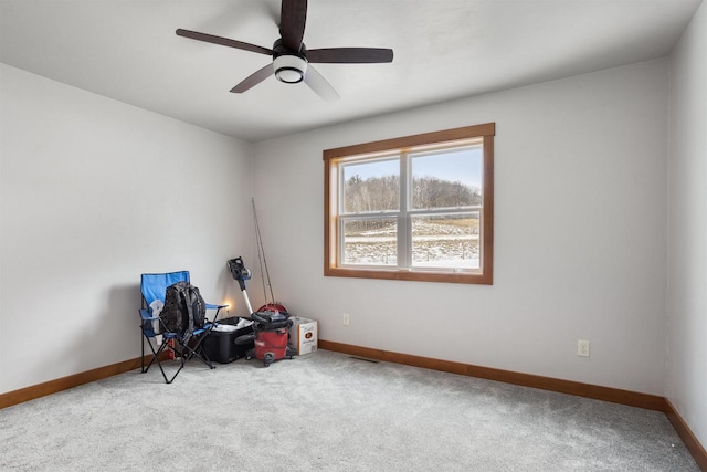 misc room featuring a ceiling fan, carpet, and baseboards