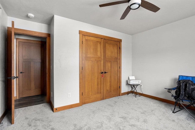 bedroom with light carpet, ceiling fan, baseboards, and a closet