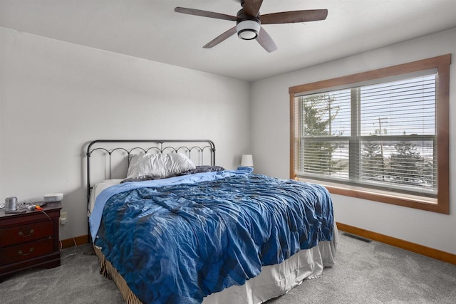 bedroom featuring carpet floors, baseboards, visible vents, and a ceiling fan