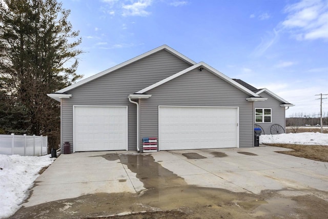 exterior space with a garage, driveway, and fence