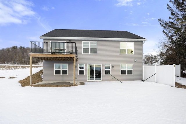 snow covered property with a wooden deck