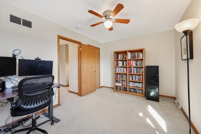 office space with visible vents, light carpet, and baseboards